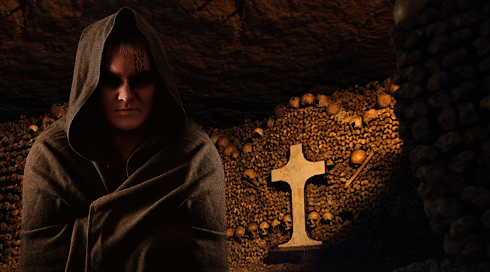 Praying monk in the Catacombs of Paris