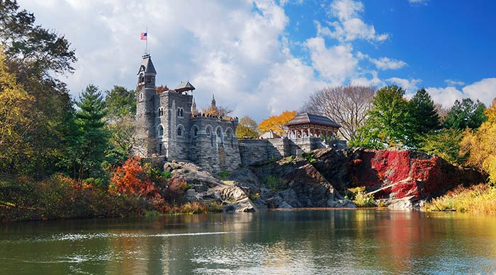 Central Park in Autumn with Belvedere Castle and colorful trees over lake with reflection