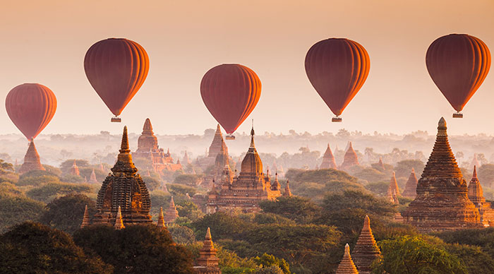 Hot air balloon over plain of Bagan in misty morning Myanmar