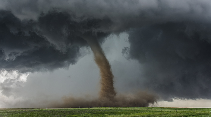 Beautiful tornado over a green field in US