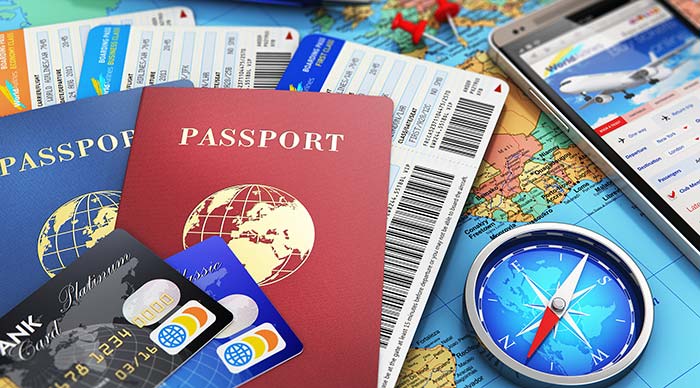 Image of Air tickets, passports, touchscreen smartphone with online airline and credit cards