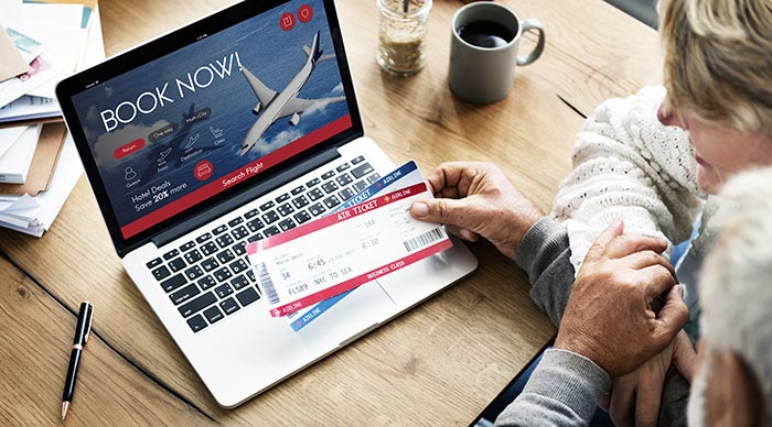 Elderly couple looking for flight tickets online