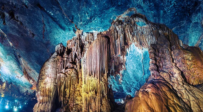 Artificially highlighted limestone formations in the cave named Paradise