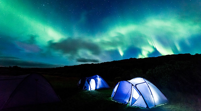 Tourists camping to see Northern Lights in Iceland