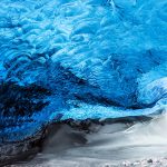 Traveler sitting in the Skaftafell glacier in Iceland